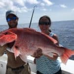 two-people-with-red-snapper